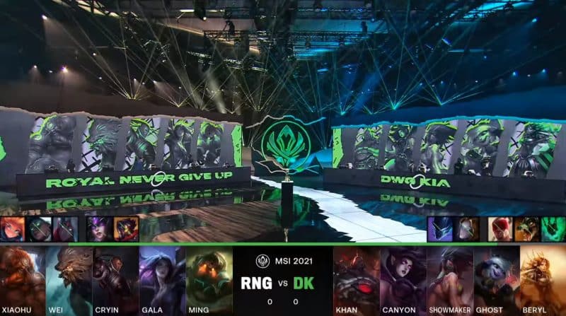 A screenshot from the LoL Esports broadcast for the Mid-Season Invitational (MSI) Grand Finals match between Royal Never Give Up (RNG) and DAMWON KIA for Game One. The picked and banned champion drafts appear at the bottom of the image with a shot of the MSI stage above.