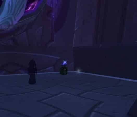 An in-game screenshot from The Alcatraz in World of Warcraft, showing a shadowy figure and a key fragment on a pedestal next to it.