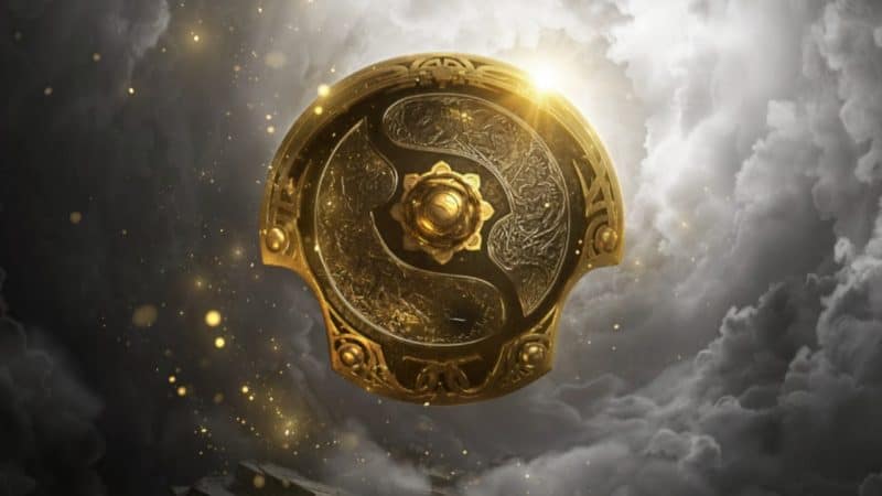 A golden Aegis for The International Dota 2 tournament appears in a smoky grey sky TI11 Predictions