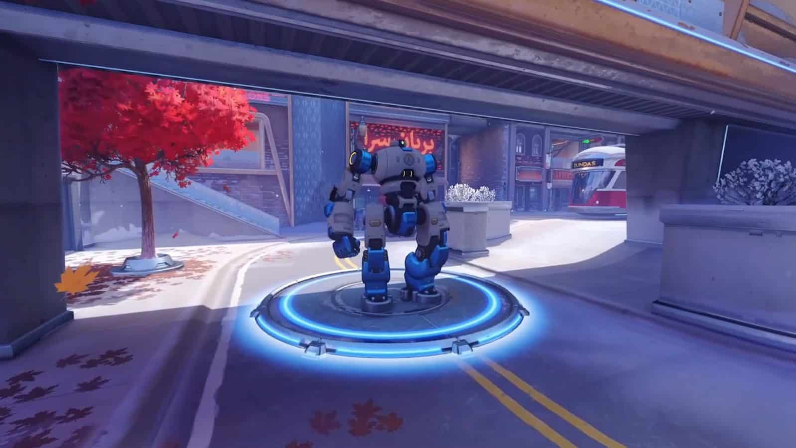 Robot T.W.O. from Overwatch 2's Push mode appears on a futuristic city street.