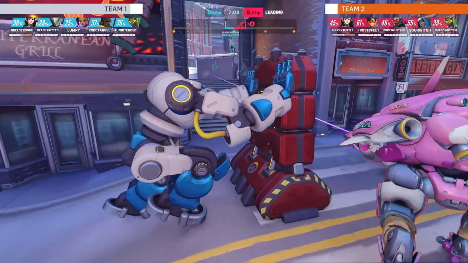 An in-game screenshot of Overwatch 2's Push mode, focusing on robot T.W.O. pushing a large barrier.