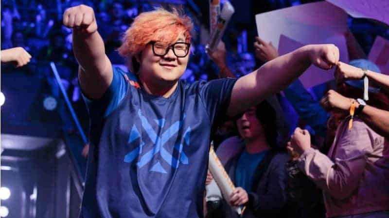 Overwatch League player Do-hyeon "Pine" Kim smiles as he fist bumps fans in the OWL arena.