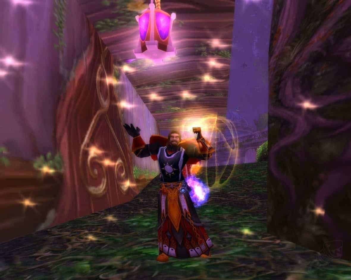 A human character shows off their Tabard of the Protector beneath one of the mighty trees of Teldrassil after the original Dark Portal event