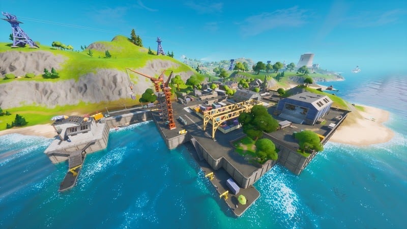 A shot of the Dirty Docks location in Fortnite, an industrial harbor on a pleasant sea.