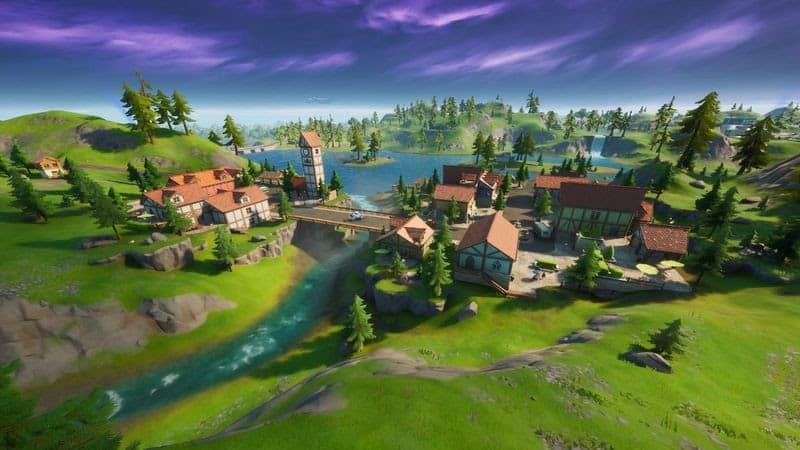 The Misty Meadows location in Fortnite, a quaint rural village near the water.