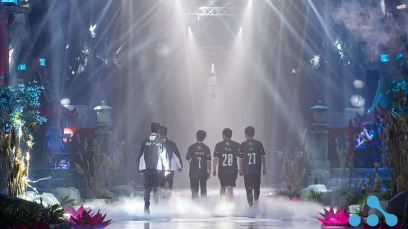 Vici Gaming's roster exit the stage after their defeat as lights shine down upon them