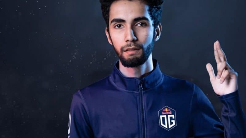 Syed Sumail "SumaiL" Hassan raises his hand in a wave toward the camera, wearing his OG jersey