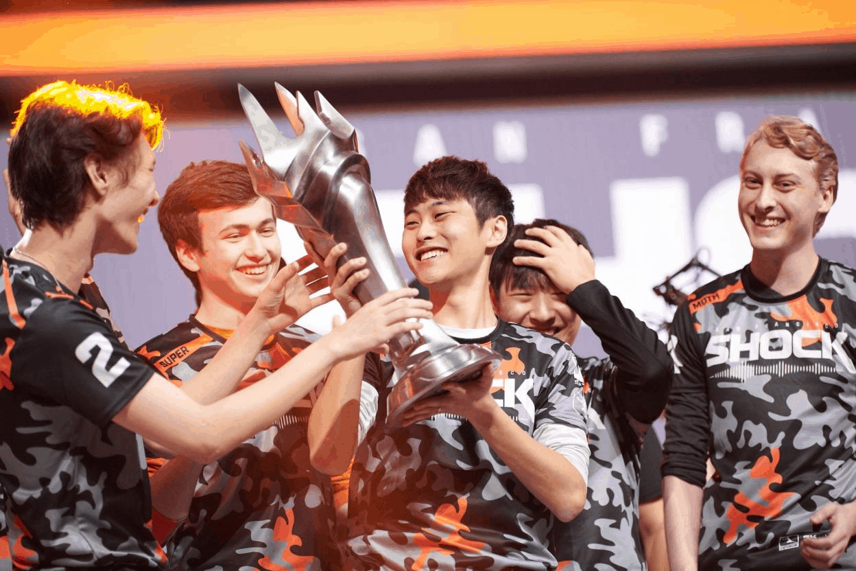 The roster for the San Francisco Shock hold aloft the Overwatch League Champions Trophy while celebrating their 2020 victory