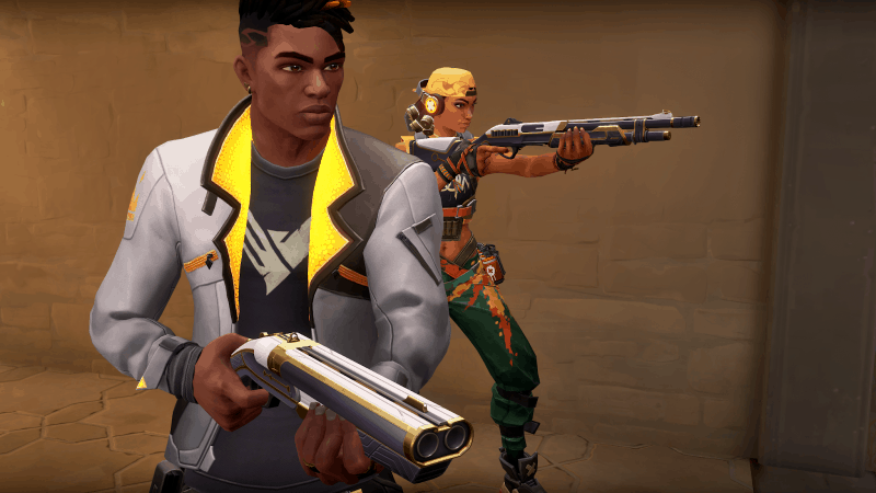 Valorant agents Phoenix and Raze skulk along the side of a building with weapons drawn