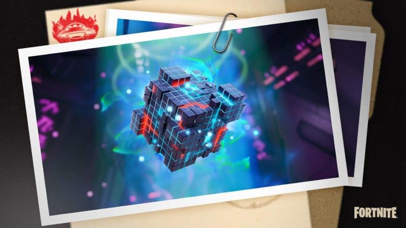 A photo of a photo of an alien nanite from Fortnite clipped onto some other pictures and a manila folder.