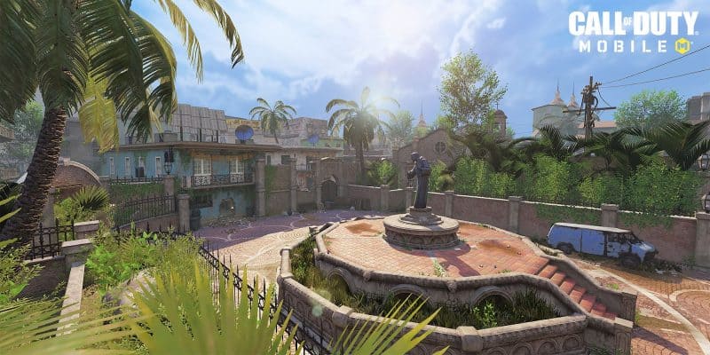 A shot of the Slums map in Call of Duty Mobile, with a statue in a park surrounded by a slum neighborhood.