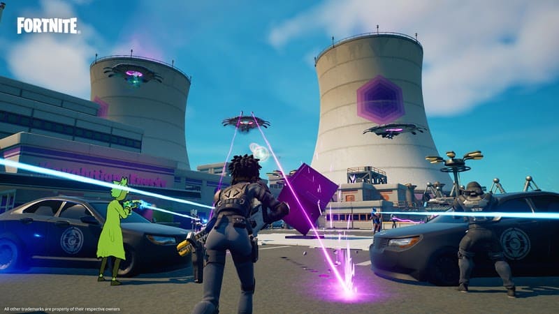 A screenshot from Fortnite showing players battling off against UFO Trespassers in a factory.