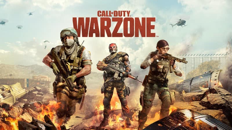 Three soldiers stand amidst burning wreckage as promo art for Call of Duty Warzone.