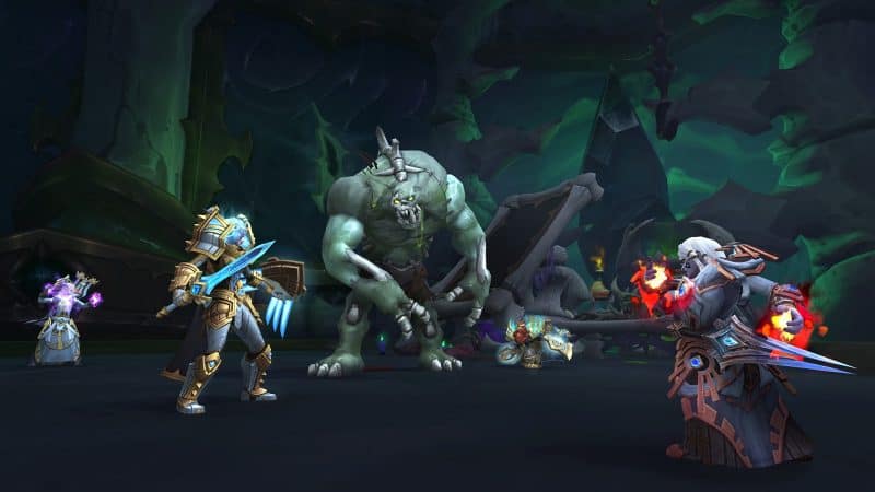 A party of heroes, including a Night Elf paladin and a Dwarf Warlock battle one of the hulking, undead foes in Shadowlands
