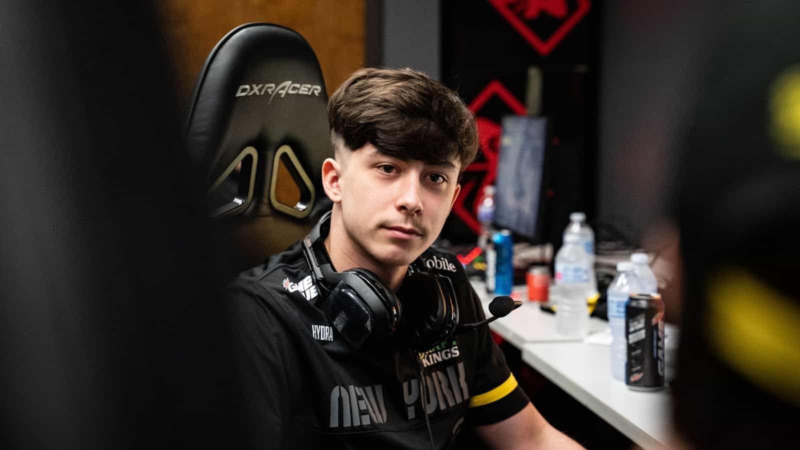 Paco "HyDra" Rusiewiez sits in a chair with a headset around his neck.
