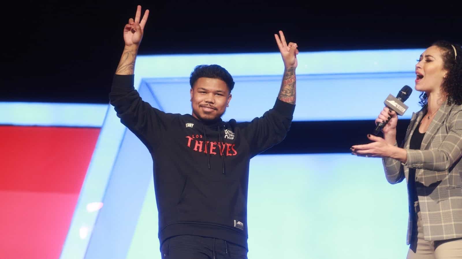 Kenneth "Kenny" Williams during an interview at the CDL Stage 5 Major as he holds his hands in "V" signs and looks towards the crowd.