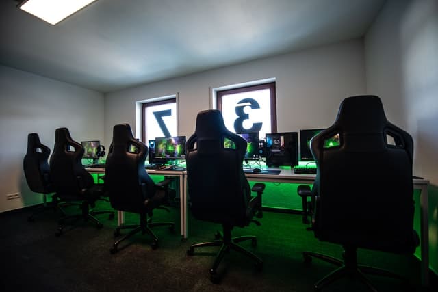 black office chairs infront of monitors