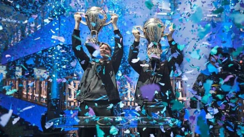 David “aqua” Wang and Emil “nyhrox” Bergquist Pedersen hold up their Duos trophy on stage in 2019 as ticker tape and confetti showers the stage