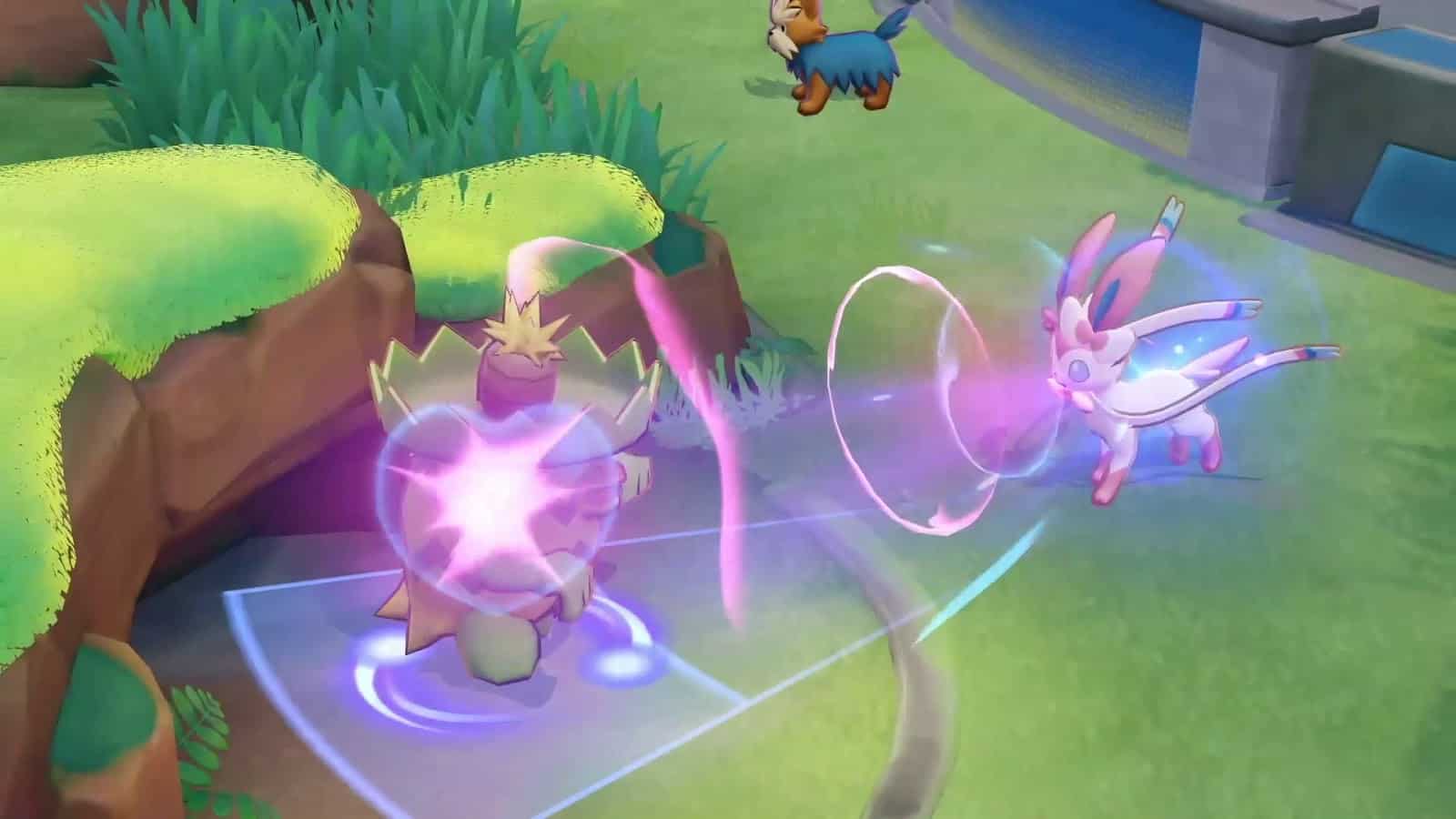 The Pokemon Sylveon, a fairy evolution of the Eevee pokemon, blasts at an enemy tower in Pokemon Unite