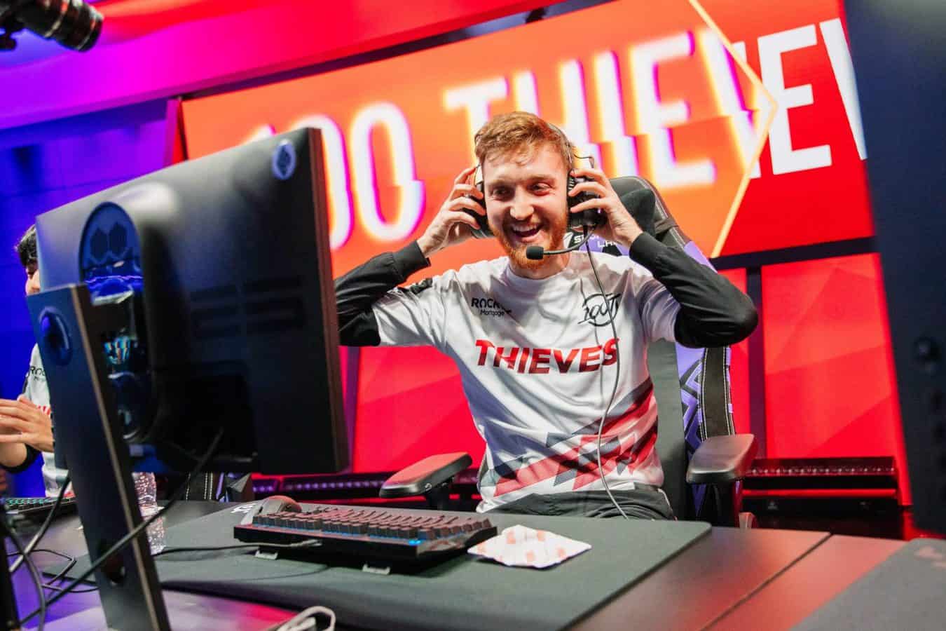 Pro LoL player for 100T Can "Closer" Çelik smiles and begins to take off his headset after an LCS victory.