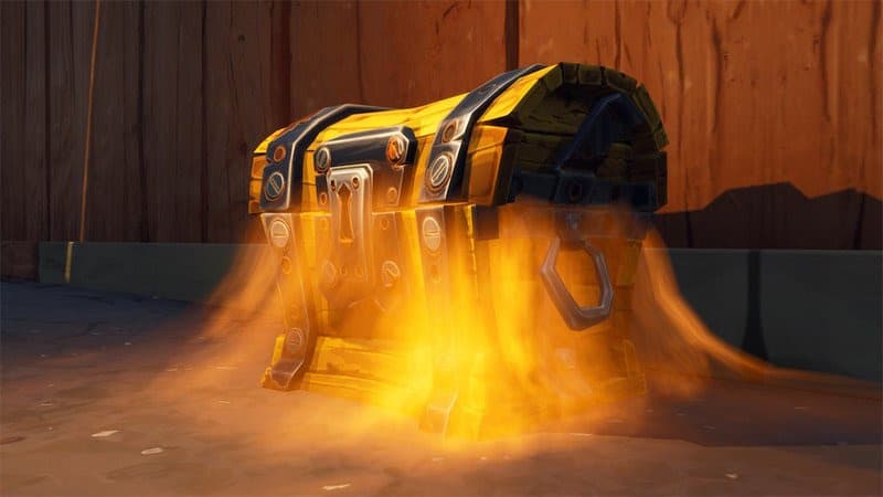 A rickety old treasure chest gives of a glowing, golden aura in the game Fortnite