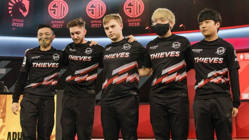 The 100 Thieves LCS roster of Ssumday, Closer, Abbedagge, Huhi and FBI stand together after a victory on the LCS stage.