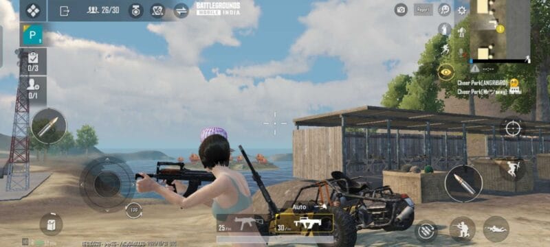 A female character from Battlegrounds Mobile India walks near a shed under a blue sky holding an assault rifle.