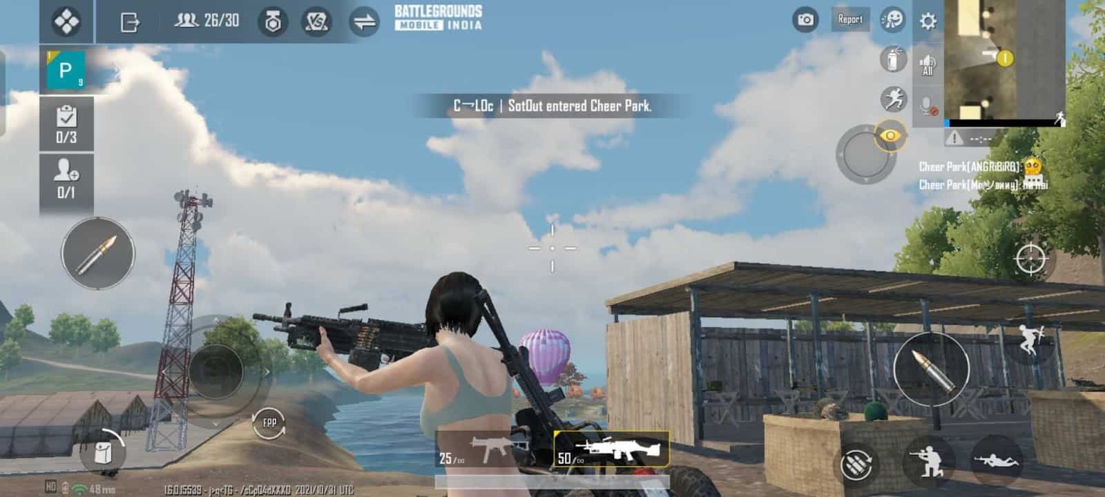 A female character from Battlegrounds Mobile India walks near a shed under a blue sky holding a light machine gun.