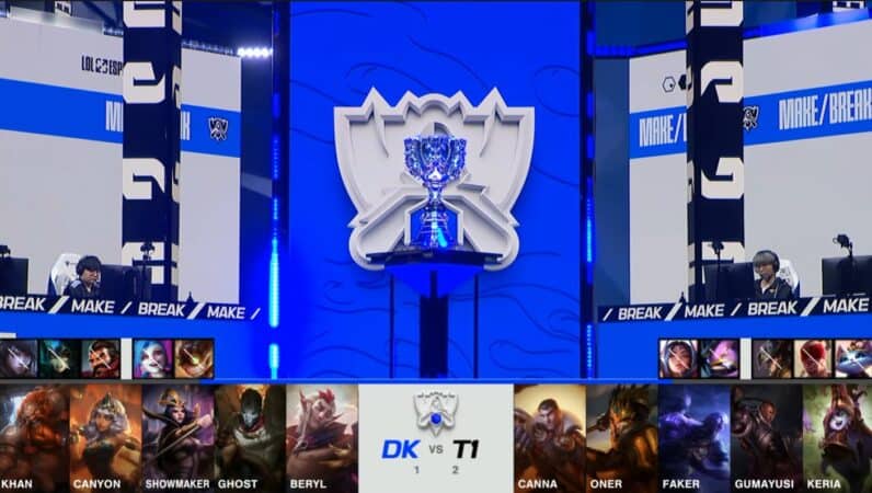 A screenshot from the 2021 World Championship Main Event Semifinals broadcast, showing the Game Four champion drafts between DAMWON KIA and T1 with a shot of the Summoner's Cup above.