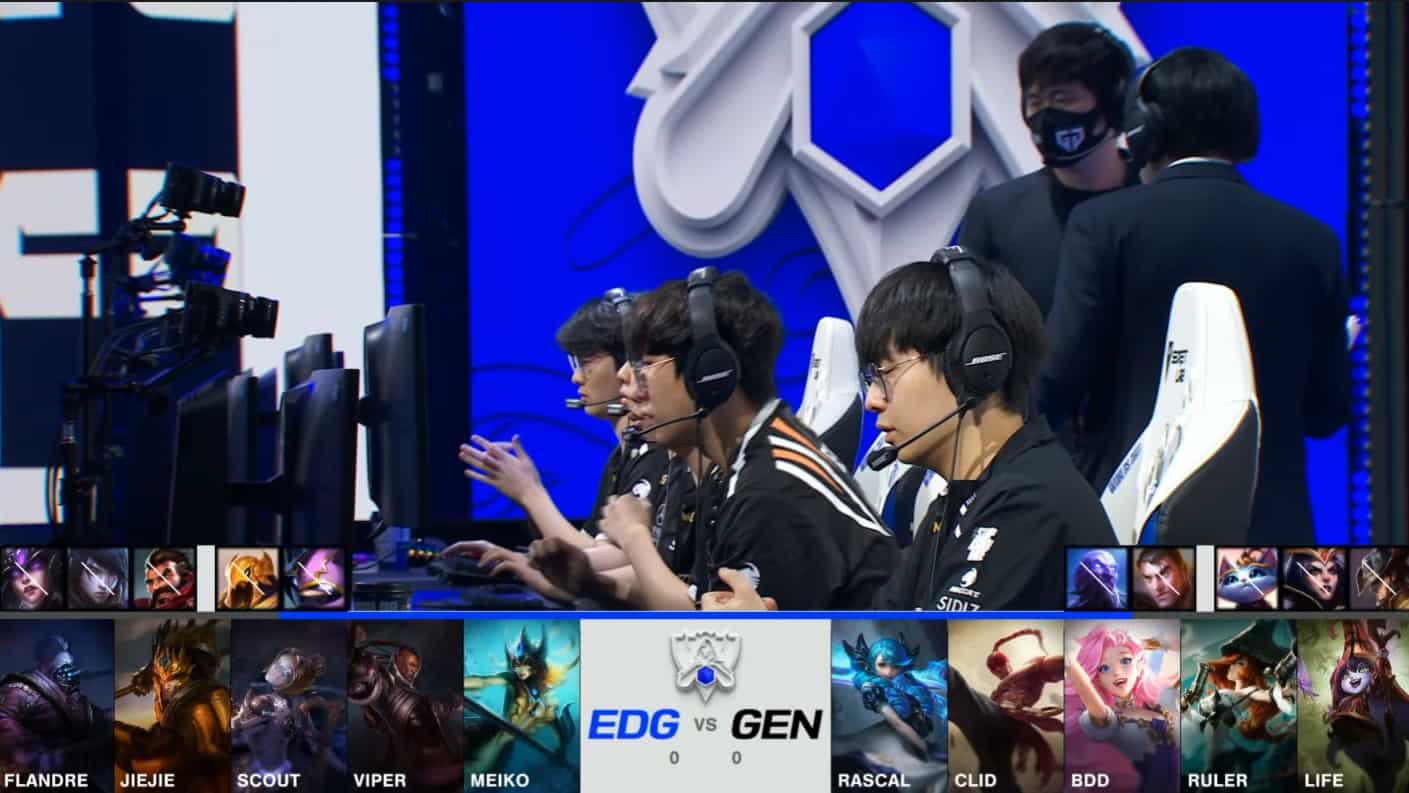 A screenshot from the 2021 World Championship Main Event Semifinals broadcast, showing the Game One champion drafts between Edward Gaming and Gen.G with a shot of the GEN LoL roster on stage above.