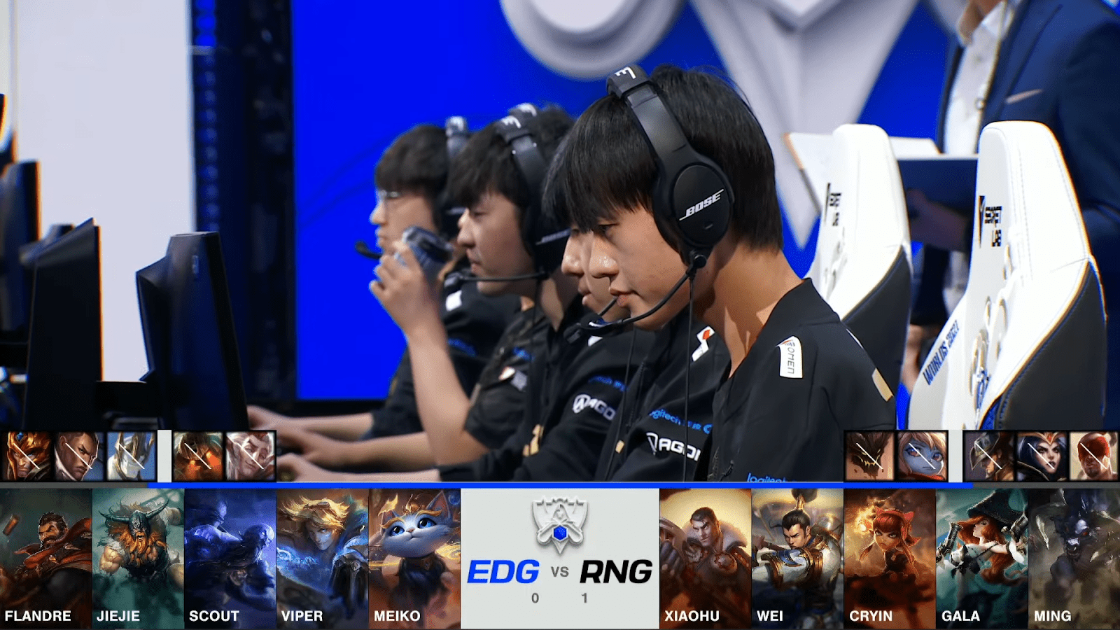 A screenshot from the 2021 World Championship Main Event Quarterfinals broadcast, showing the Game Two champion drafts between Royal Never Give Up and Edward Gaming with a shot of the RNG LoL squad on stage above.