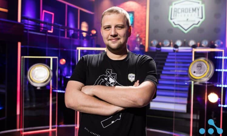 Eugene Shepelev, lead esports manager at WePlay Esports stands with his arms and a smile on his face in the Academy league studio.