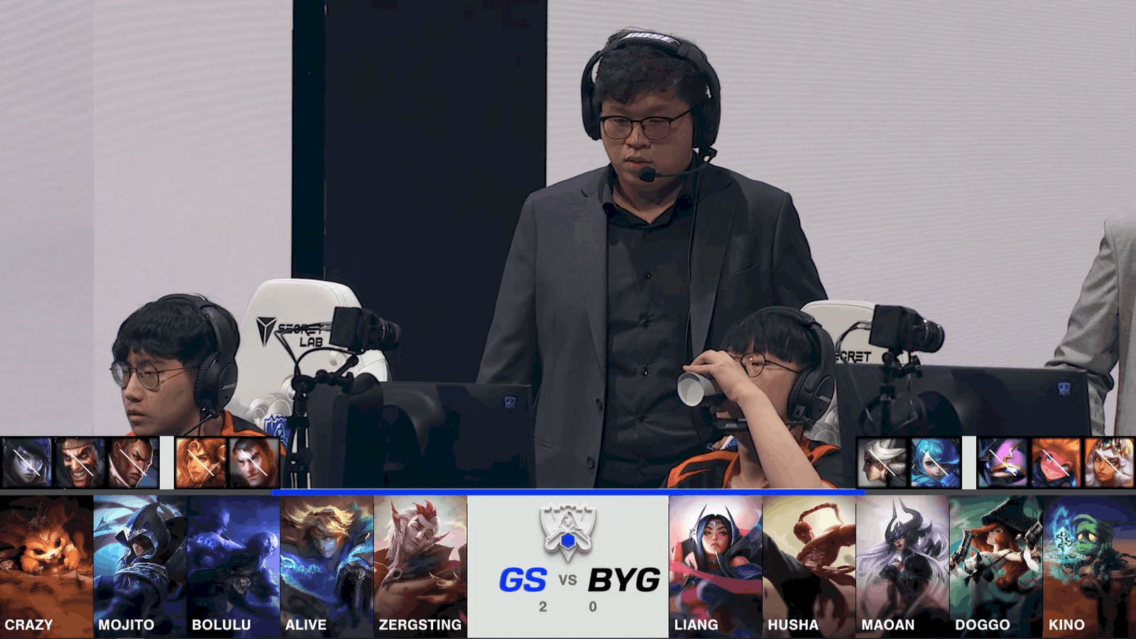 A screenshot from the 2021 World Championship Play-in Knockouts broadcast, showing the Game Three drafts between Beyond Gaming and Galatasaray Esports with a shot of the BYG coach and players on stage in the middle.
