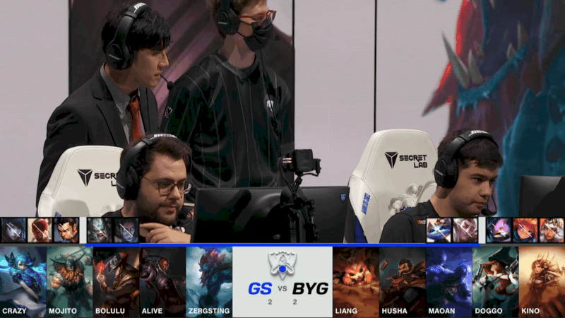 A screenshot from the 2021 World Championship Play-in Knockouts broadcast, showing the Game Five drafts between Beyond Gaming and Galatasaray Esports with a shot of the Beyond Gaming players and coaches on stage in the middle.