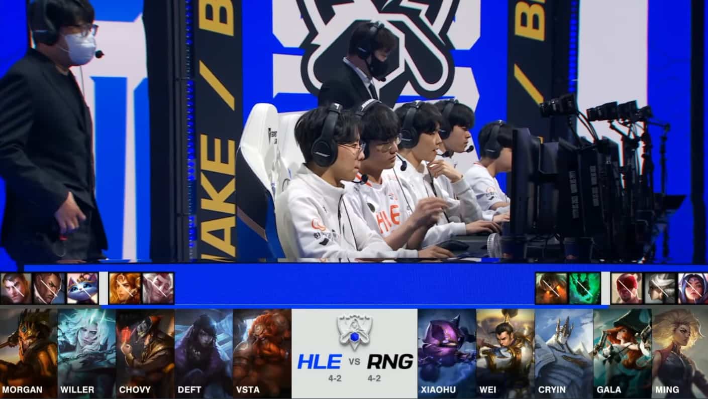 A screenshot from the 2021 World Championship Main Event Group Stage broadcast, showing the champion drafts for the tiebreaker match between Hanwha Life and RNG with a shot of the HLE players and coaches on stage above.