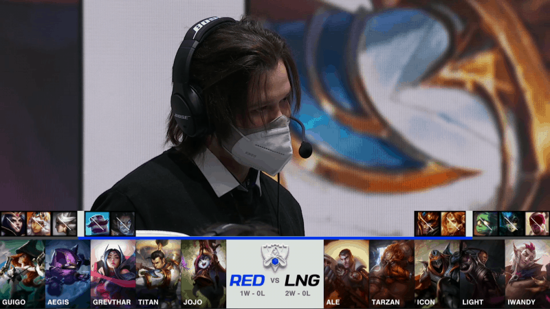 A screenshot from the 2021 World Championship Play-ins broadcast, showing the drafts between RED Canids and LNG Esports with a shot of coach Calisto "Coelho" Coelho Rabaiolli Clavé in the middle.