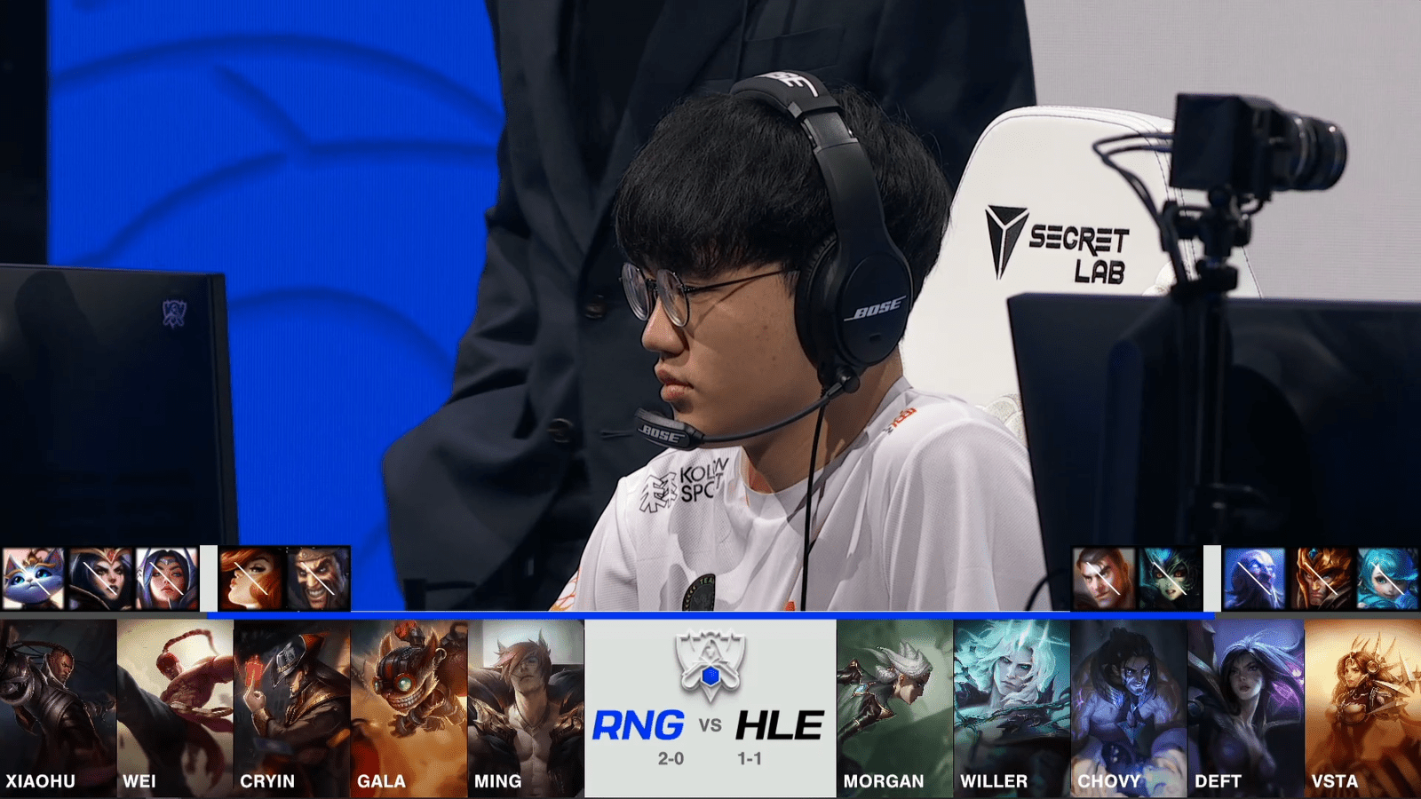 A screenshot from the 2021 World Championship Main Event Group Stage broadcast, showing the champion drafts between Royal Never Give Up and Hanwha Life Esports with a shot of HLE jungler Willer above.