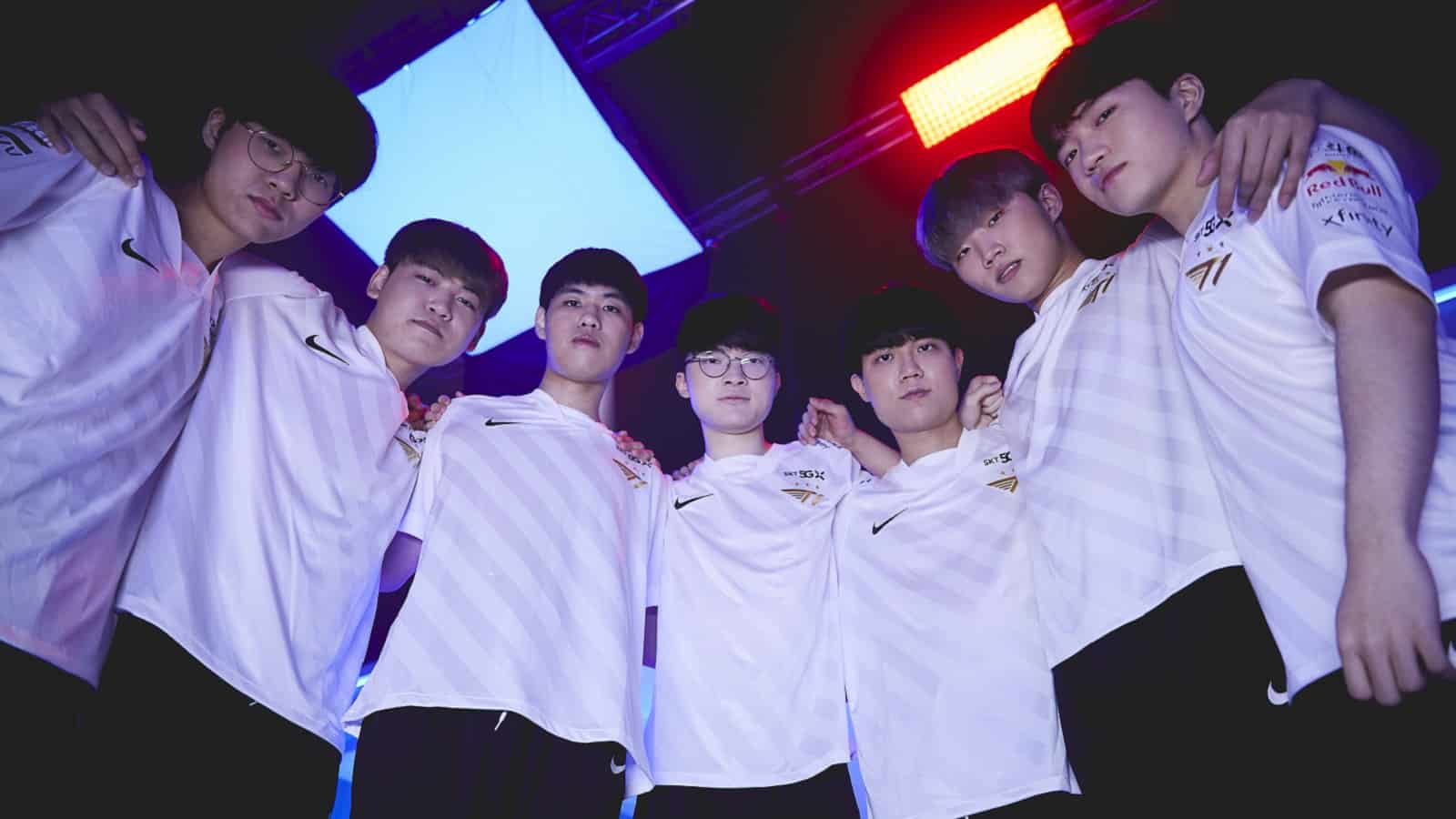 The 2021 T1 LoL roster huddles together and looks down at the camera intimidatingly.
