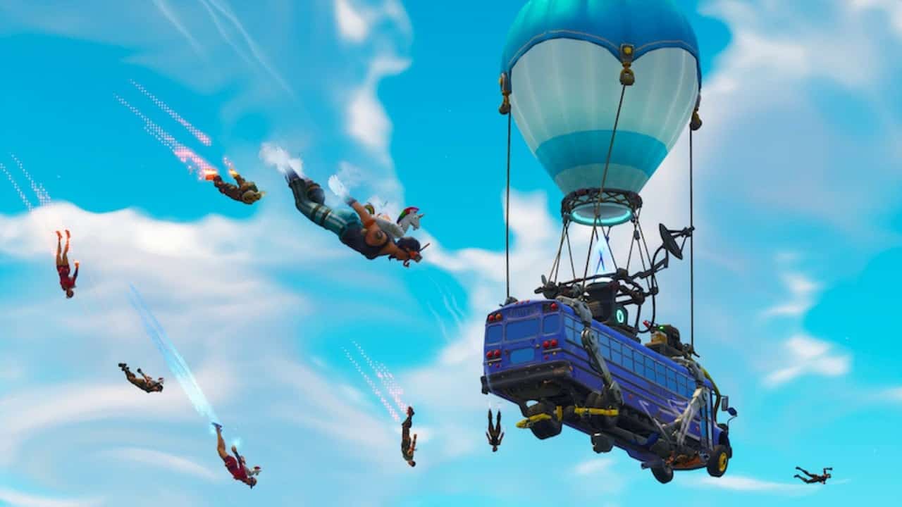 The iconic Battle Bus from Fortnite flies through the sky with player characters diving out from it.