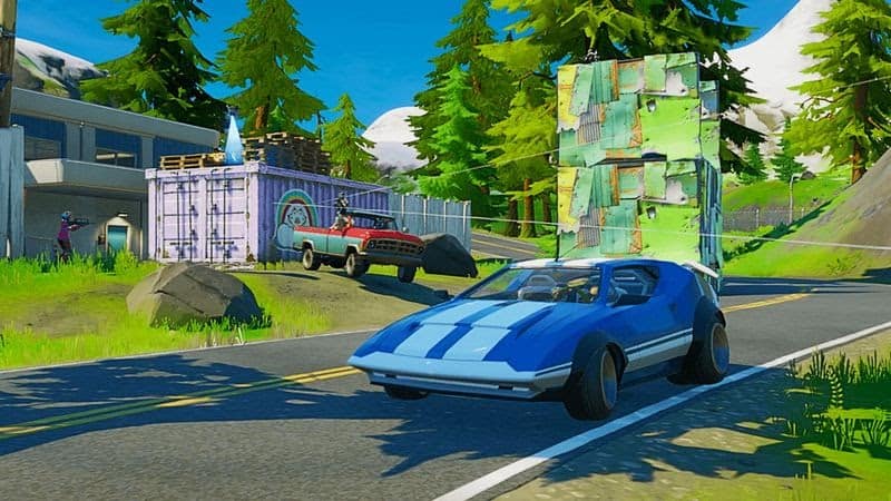 An in-game screenshot of a blue car at a pleasant location in Fortnite.