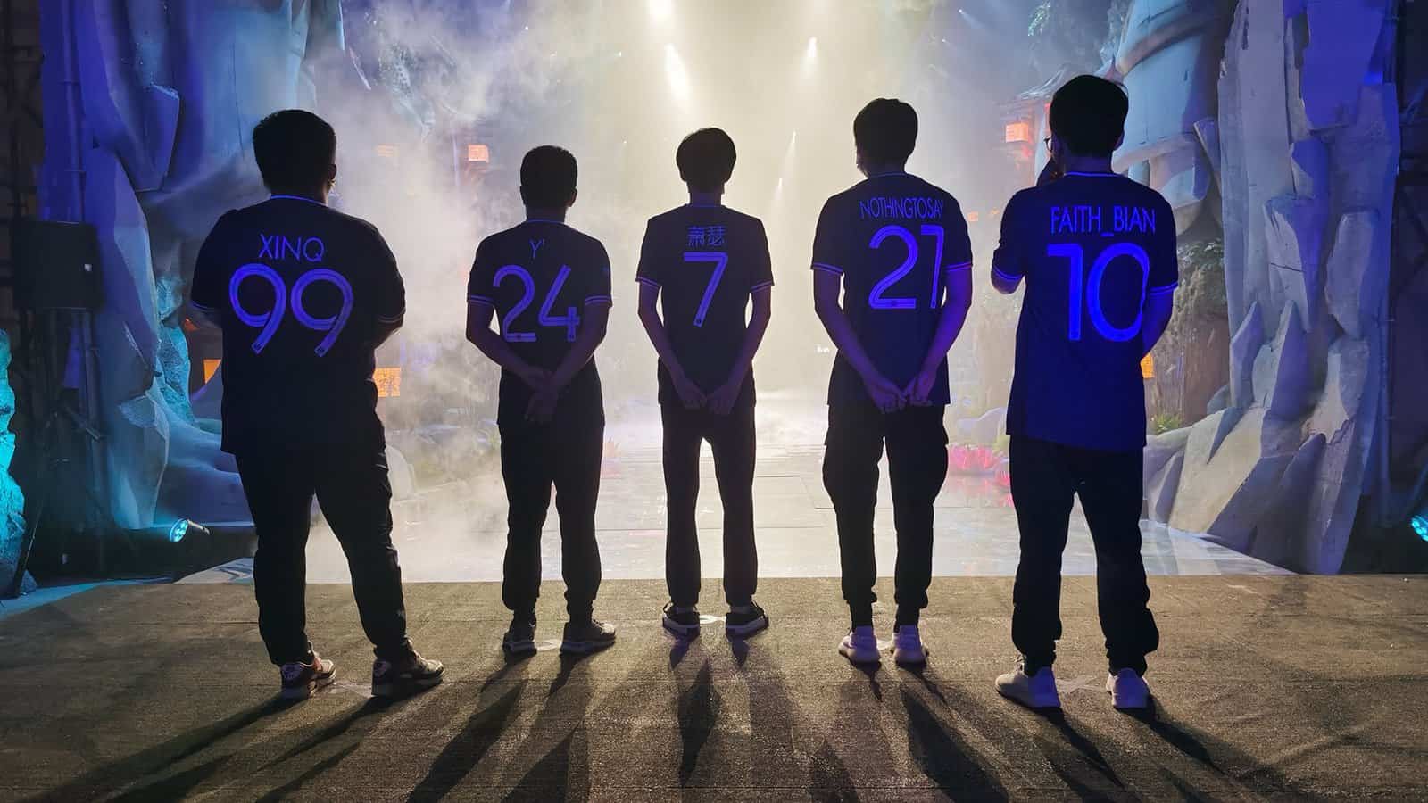 The roster for PSG.LGD stand facing the AniMajor stage ahead, their tagnames are visible on the backs of their jerseys