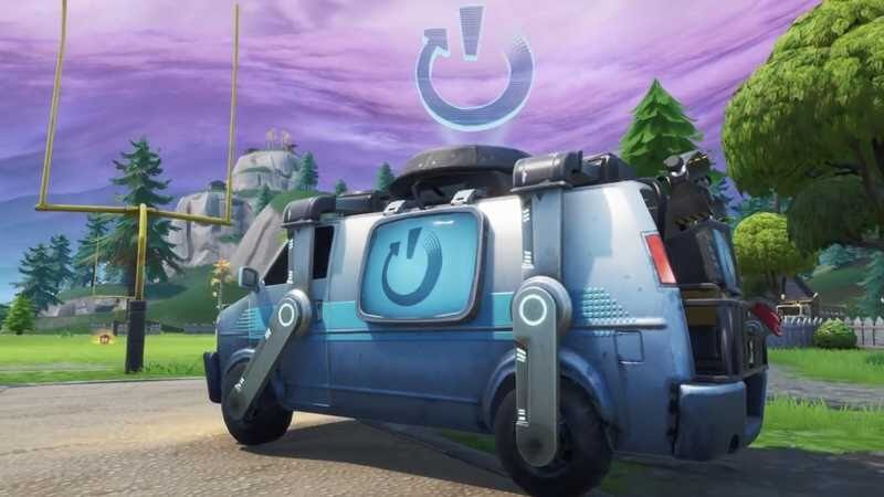 The reboot van from Fortnite, showing the flashing power symbol on the side windows and above the roof of the vehicle