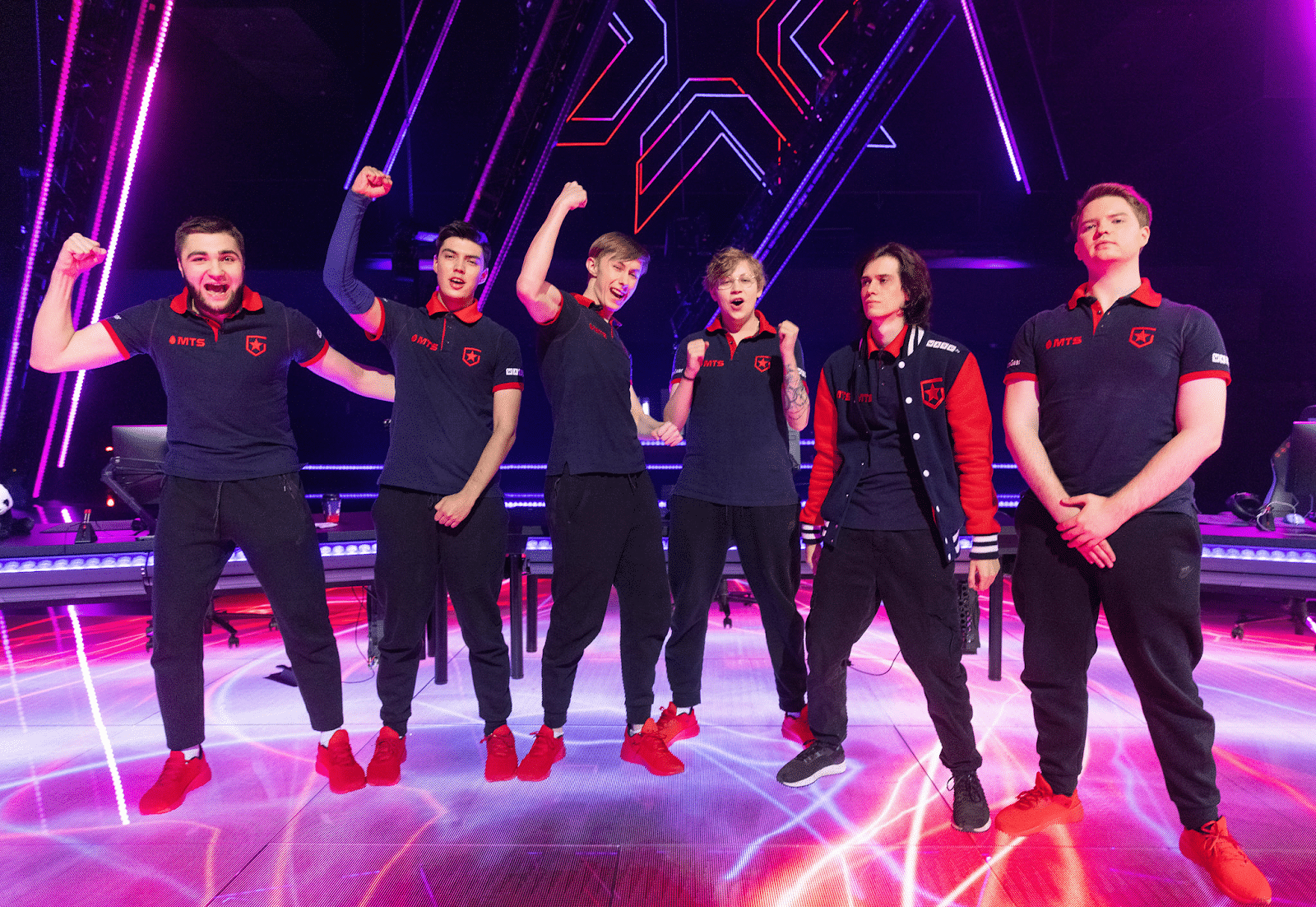 The roster for Gambit Esports stand on the stage and cheer at Valorant Champions 2021