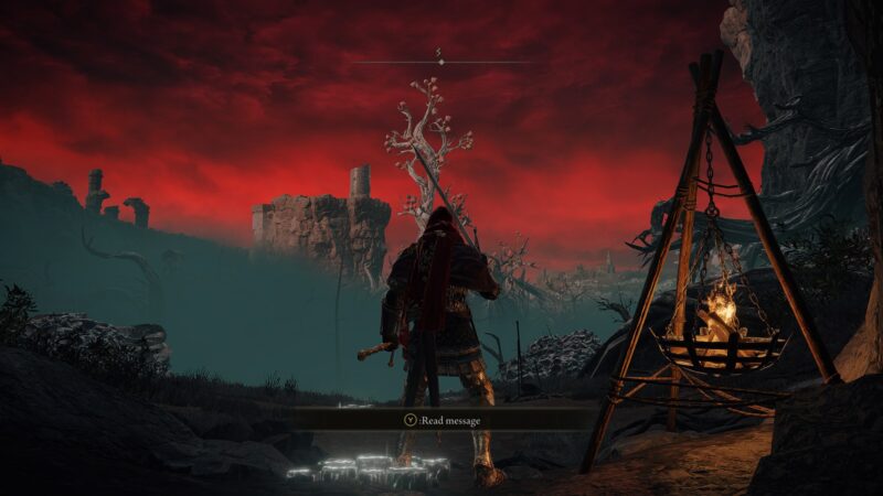 A player character in Elden Ring pauses to read a message from a visitor