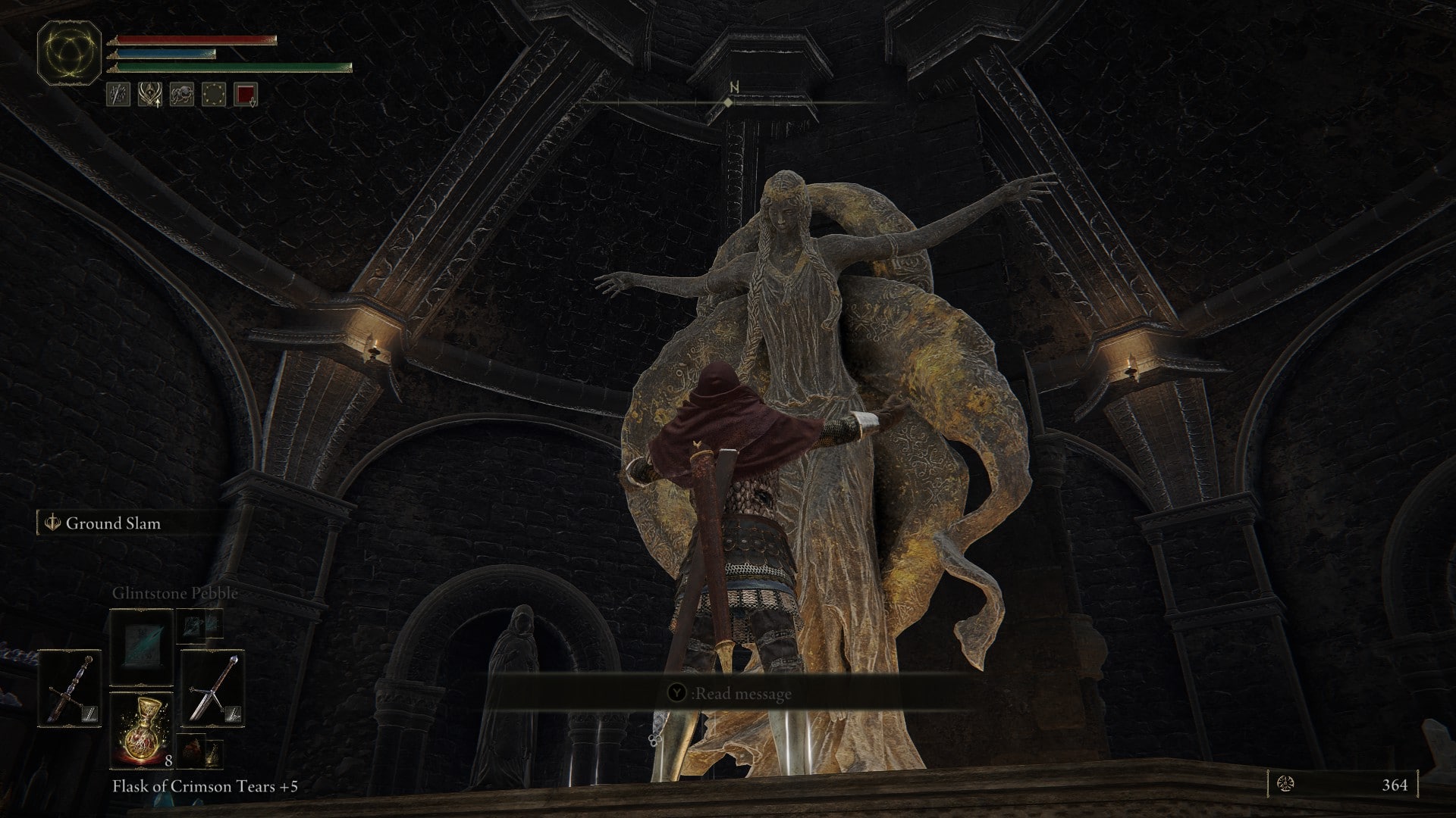 A character in Elden Ring interacts with the statue of a woman with long braided hair